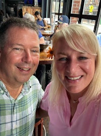 a man and woman taking a selfie at a restaurant