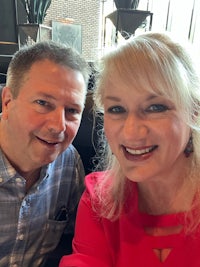 a man and woman posing for a photo in a restaurant