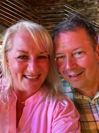 a man and woman posing for a selfie in a restaurant