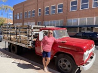 a woman standing in front of a red truck
