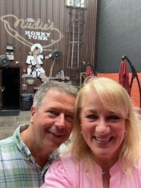 a man and woman taking a selfie in front of a building